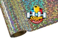 Silver Hearts Textile Foil: A roll of metallic foil material with a shiny silver finish, adorned with a pattern of small holographic hearts. The foil is designed to add a decorative touch to textiles, cards, and fabrics.